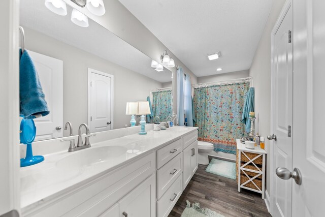 bathroom featuring vanity, hardwood / wood-style flooring, toilet, and a shower with shower curtain