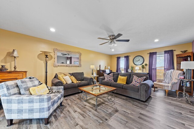 living room featuring hardwood / wood-style floors and ceiling fan