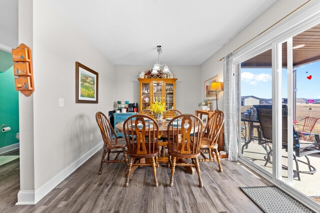 dining space featuring hardwood / wood-style flooring and a notable chandelier