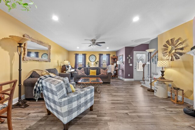 living room with hardwood / wood-style flooring, ceiling fan, and a healthy amount of sunlight