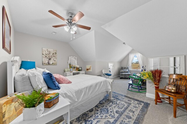 bedroom with ceiling fan, lofted ceiling, and carpet flooring