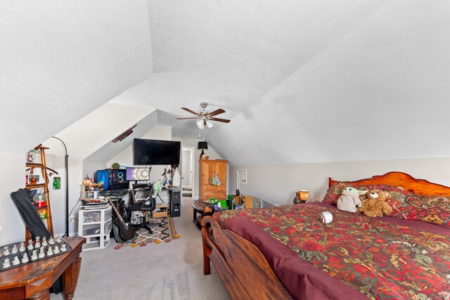 bedroom with vaulted ceiling, light colored carpet, and ceiling fan