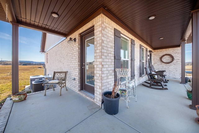 view of patio featuring a rural view and a porch