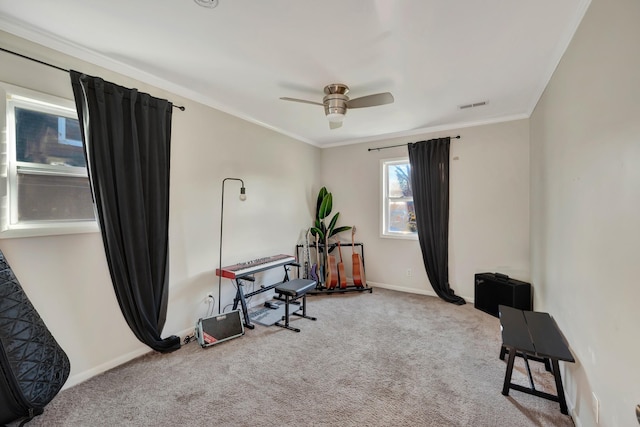 interior space with ceiling fan, carpet floors, and crown molding