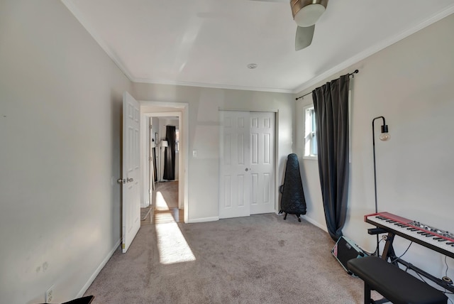 bedroom with ceiling fan, light colored carpet, a closet, and ornamental molding