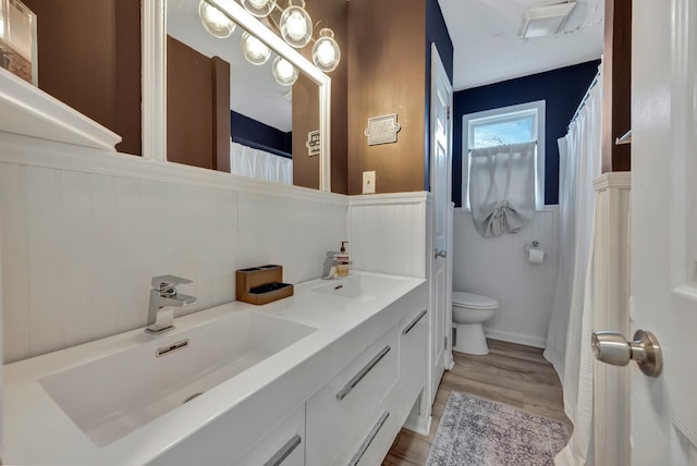 bathroom featuring toilet, vanity, and wood-type flooring