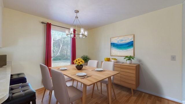 dining area featuring hardwood / wood-style floors and an inviting chandelier