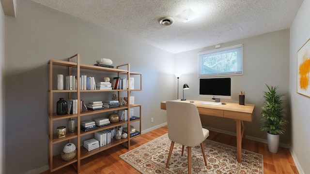 office space featuring hardwood / wood-style flooring and a textured ceiling