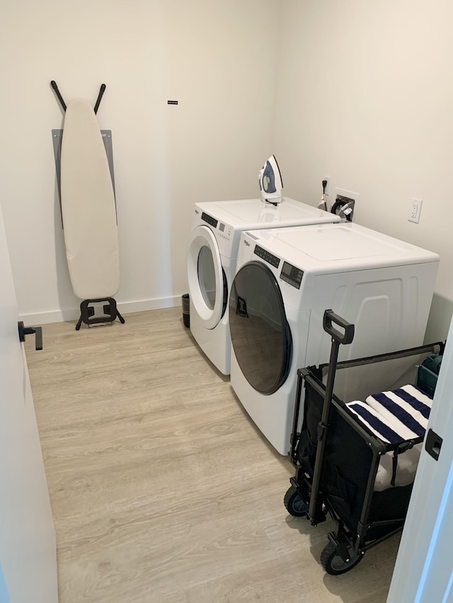 washroom featuring independent washer and dryer and light wood-type flooring