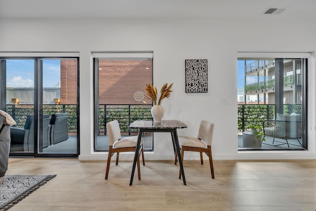 dining space with light hardwood / wood-style flooring