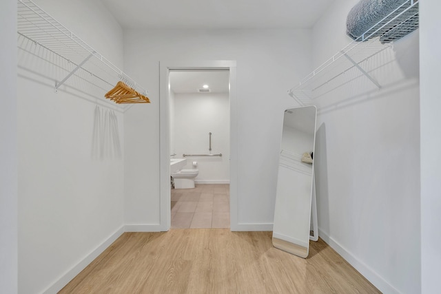 spacious closet featuring hardwood / wood-style flooring