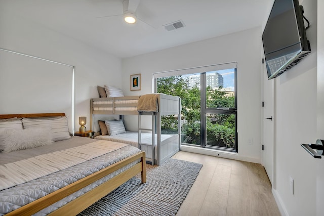 bedroom featuring multiple windows, ceiling fan, and light hardwood / wood-style flooring