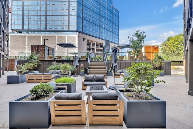 view of patio / terrace with an outdoor living space with a fire pit