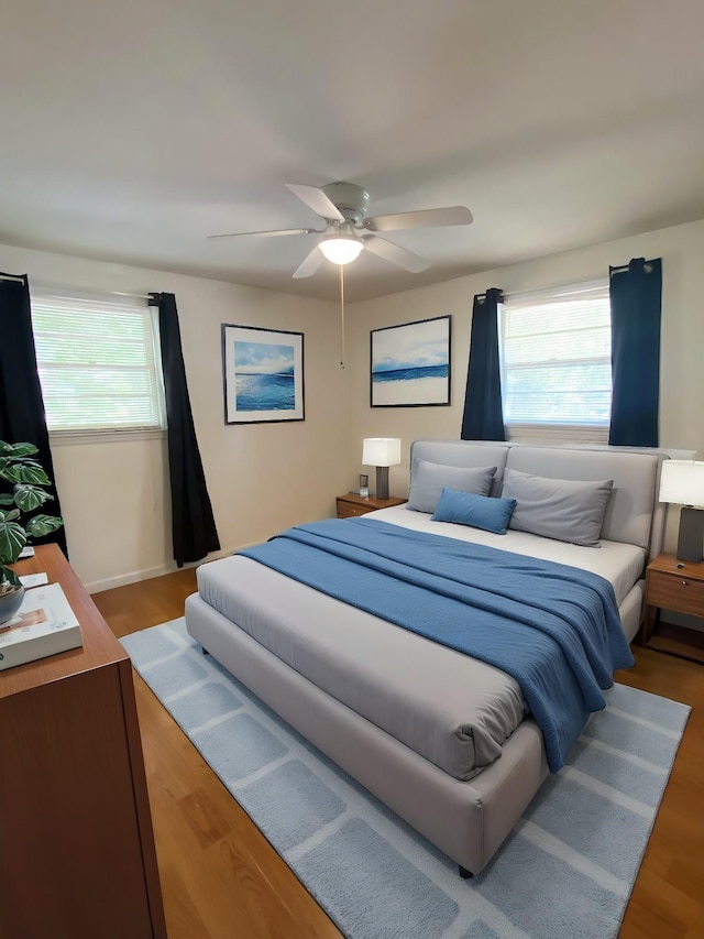 bedroom with ceiling fan and hardwood / wood-style floors