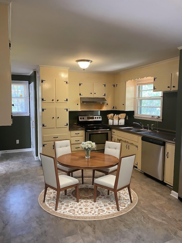 kitchen featuring cream cabinets, sink, crown molding, and appliances with stainless steel finishes