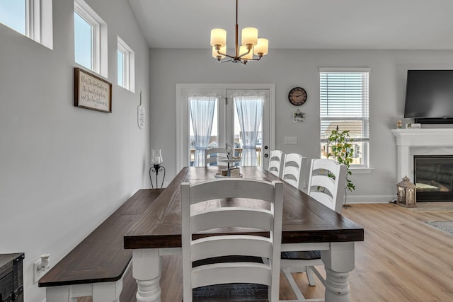 dining space featuring light hardwood / wood-style floors and a chandelier