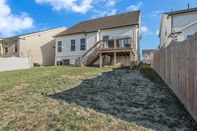 rear view of property with a yard and a deck