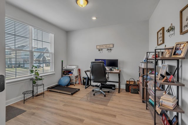 home office with a healthy amount of sunlight and light wood-type flooring