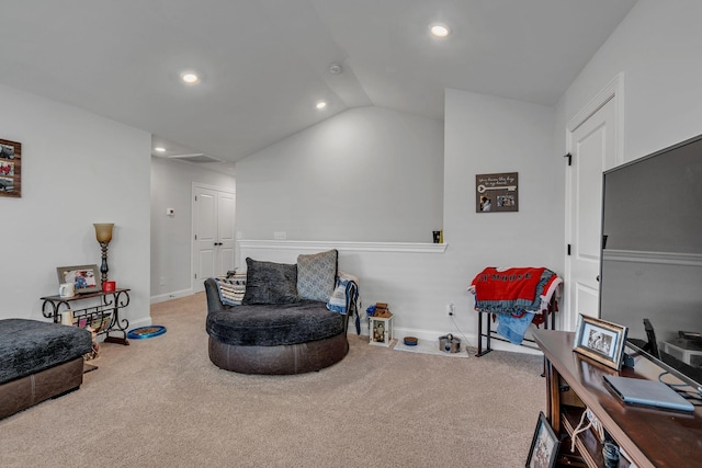 living area featuring carpet and vaulted ceiling