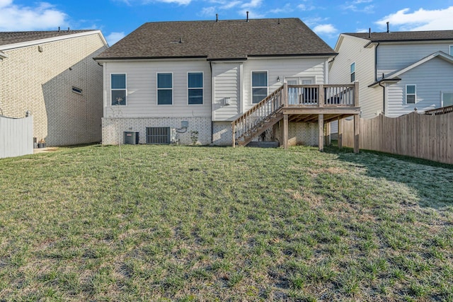 back of house featuring central AC, a yard, and a deck