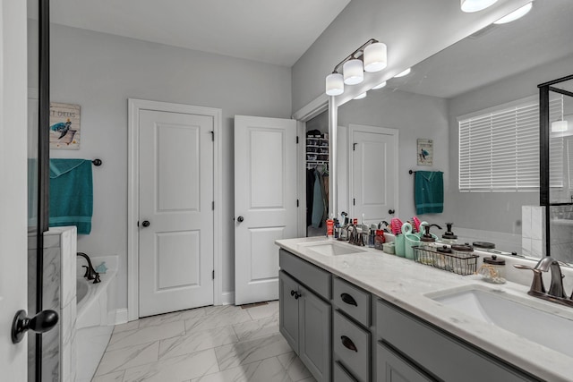 bathroom featuring vanity and a tub to relax in