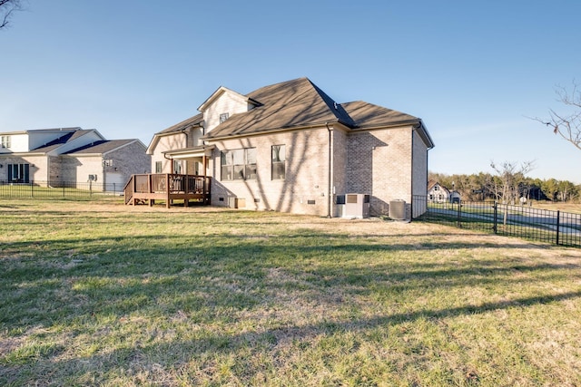 back of house with a yard and a deck