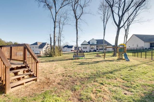 view of yard with a playground and a trampoline