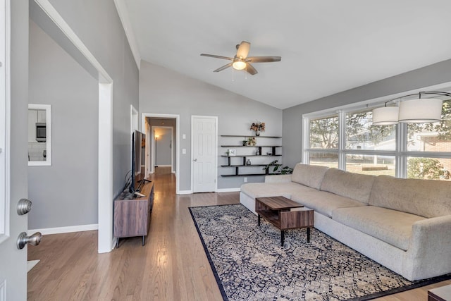 living room featuring ceiling fan, hardwood / wood-style floors, and high vaulted ceiling