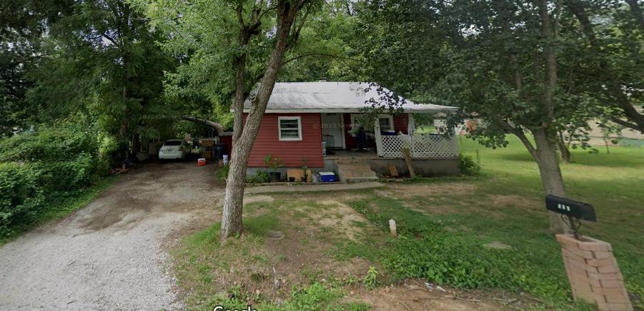 ranch-style house with a front lawn and covered porch