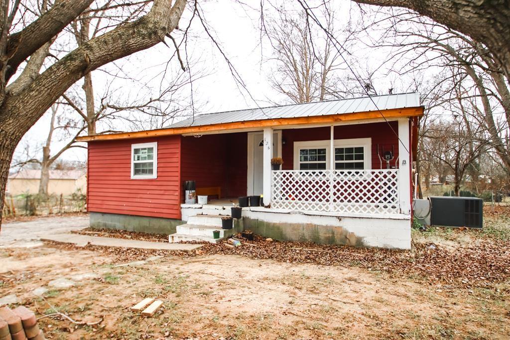 view of front facade with a porch and cooling unit