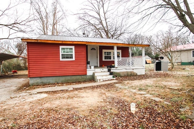 view of front of home with a carport and covered porch