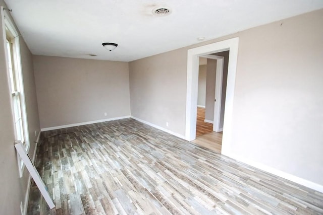 spare room with light hardwood / wood-style flooring