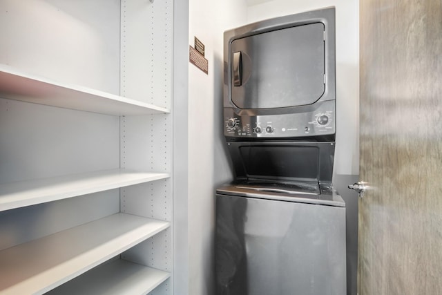 laundry room with stacked washing maching and dryer