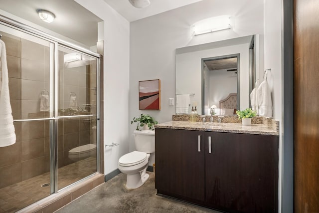 bathroom with concrete flooring, vanity, toilet, and walk in shower