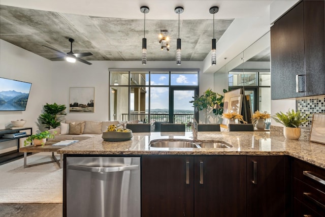 kitchen with sink, hanging light fixtures, stainless steel dishwasher, ceiling fan, and light stone counters