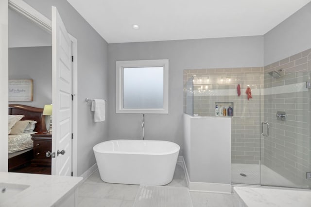 bathroom featuring tile patterned flooring, vanity, and shower with separate bathtub