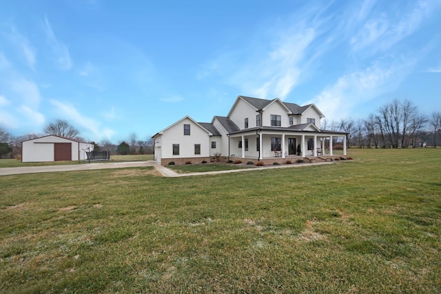 view of front of home featuring a front lawn, covered porch, an outdoor structure, and a garage