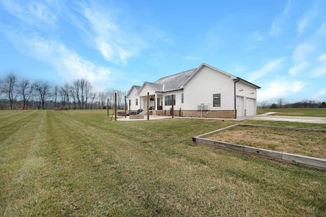 view of side of home with a garage and a lawn