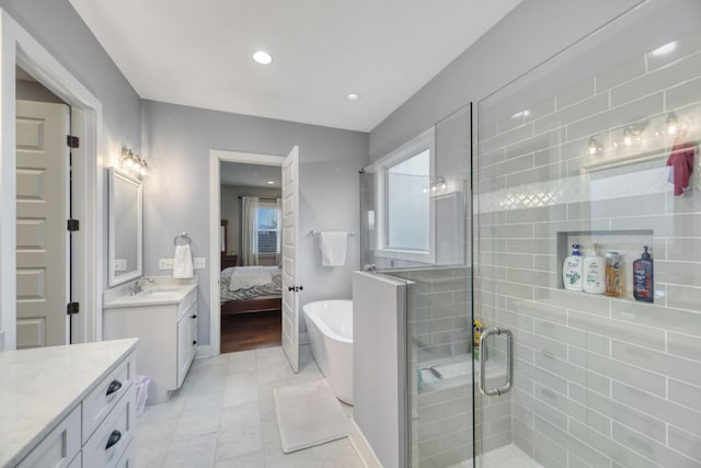 bathroom with separate shower and tub and vanity