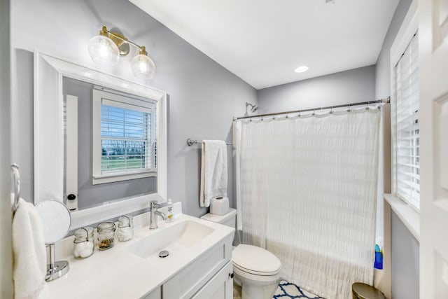 full bathroom featuring vanity, shower / tub combo, and toilet