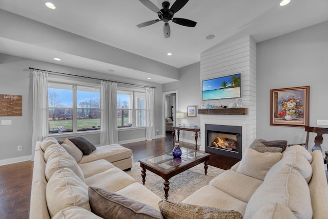 living room with hardwood / wood-style floors, ceiling fan, lofted ceiling, and a fireplace