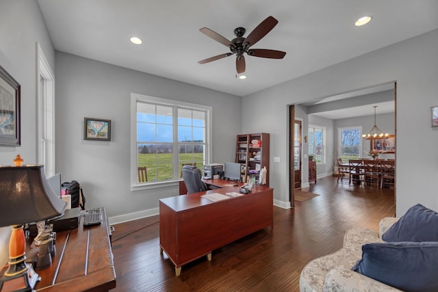 office area with dark hardwood / wood-style floors and ceiling fan with notable chandelier