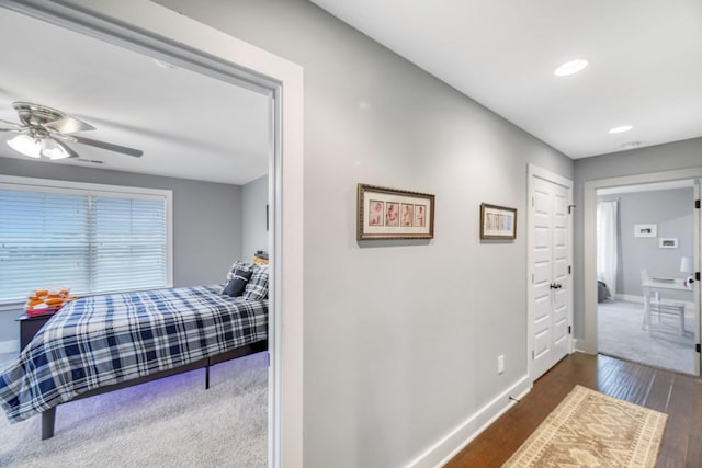 bedroom with a closet, ceiling fan, and dark wood-type flooring