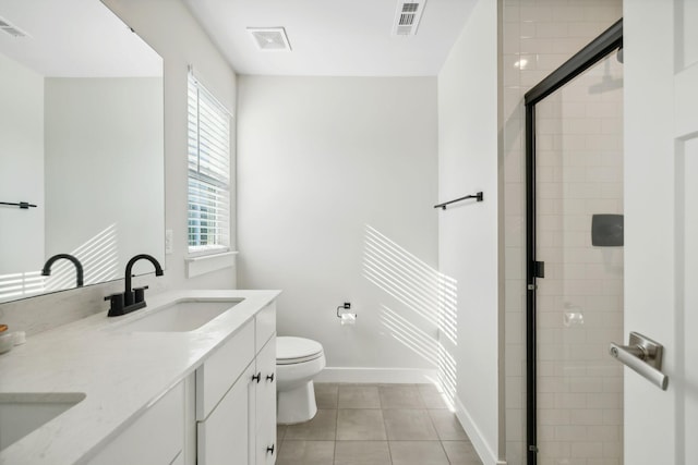 bathroom featuring tile patterned floors, vanity, toilet, and a wealth of natural light