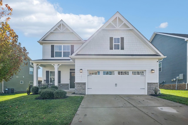 craftsman-style home featuring a porch, a garage, central air condition unit, and a front yard