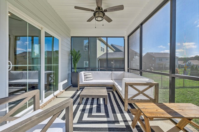 unfurnished sunroom with ceiling fan