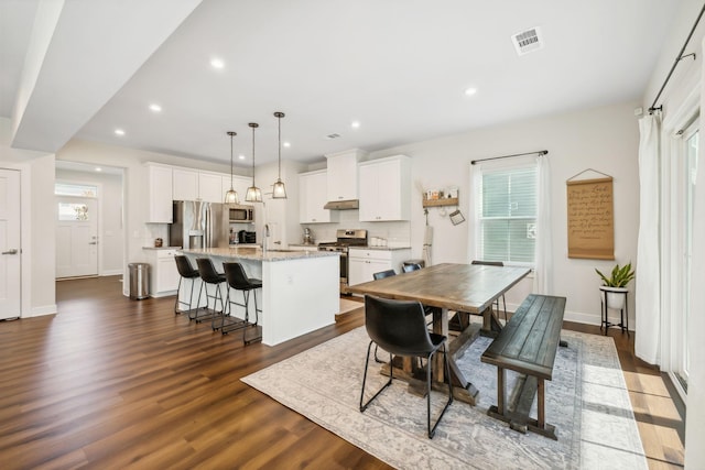 dining room with dark hardwood / wood-style floors and sink