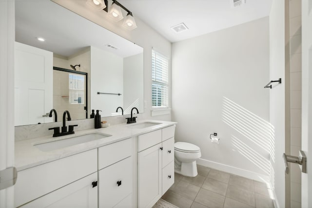 bathroom featuring tile patterned floors, vanity, toilet, and an enclosed shower