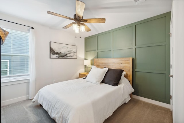 carpeted bedroom with multiple windows and ceiling fan