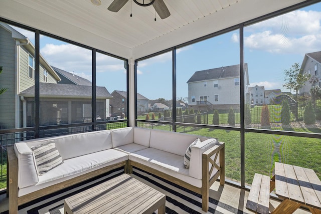 sunroom with ceiling fan and wooden ceiling